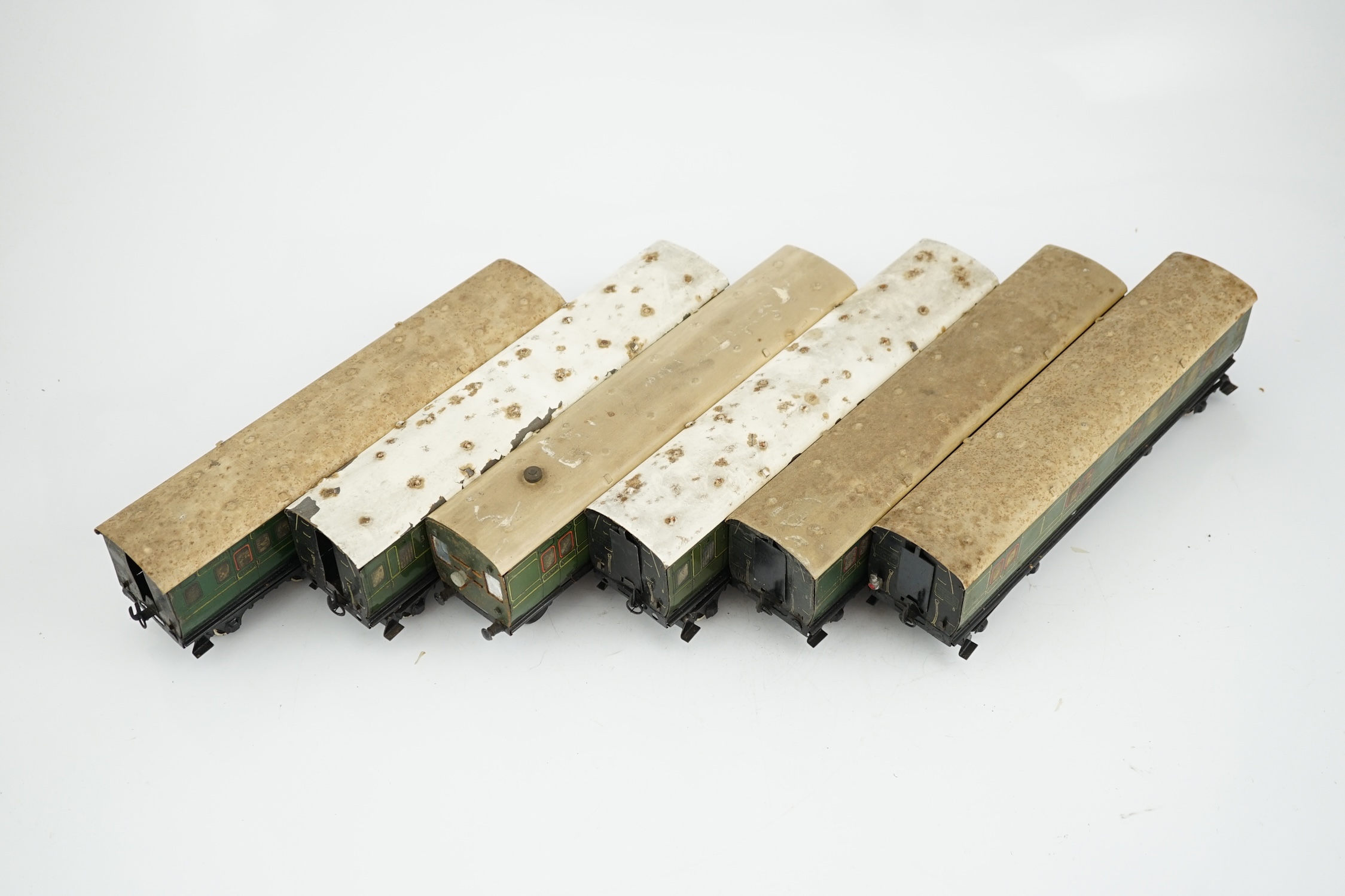 Six Hornby 0 gauge tinplate No.2 coaches in Southern Railway livery, one coach adapted to a driving unit with clockwork motor and replacement bogie
